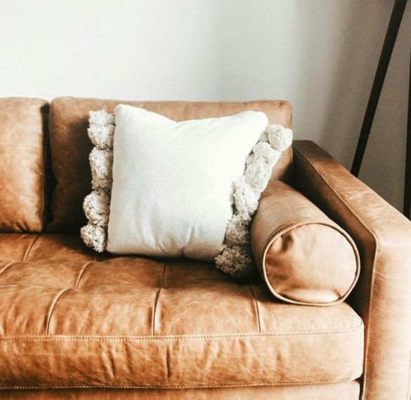 Cozy therapy room featuring a couch with a pillow and a floor lamp